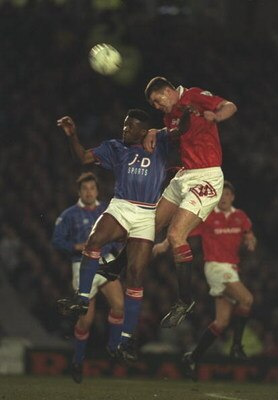 13 Apr 1994:  Darren Beckford (left) of Oldham and Gary Pallister (right) of Manchester United both jump for the ball during the FA Cup semi-final replay at Maine Road in Manchester. Manchester United won the match 4-1. \ Mandatory Credit: Clive  Brunskil