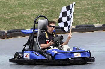 DALLAS -  APRIL 1:   NASCAR driver Denny Hamlin takes a victory lap after racing Dallas Cowboys tight end Jason Whitten at SpeedZone , April 1, 2009 in Dallas, Texas.  The pair were racing to raise awareness for the March of Dimes and the 2009 March for B