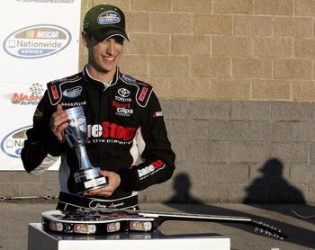 LEBANON, TN - APRIL 11:  Joey Logano, driver of the #20 GameStop Toyota is all smiles as he hold the the winners trophyies after winning the NASCAR Nationwide Series Pepsi 300 at the Nashville Superspeedway  on April 11, 2009 in Lebanon,Tennessee.   (Phot