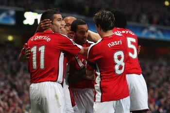 LONDON, ENGLAND - APRIL 15:  Theo Walcott (C) of Arsenal is congratulated by team mates after scoring the first goal of the game during the UEFA Champions League Quarter Final Second Leg match between Arsenal and Villarreal at the Emirates Stadium on Apri