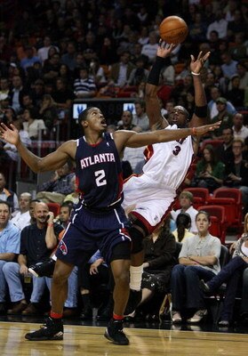 MIAMI - DECEMBER 12:  Joe Johnson #2 of the Atlanta Hawks fouls Dwyane Wade #3 of the Miami Heat at American Airlines Arena on December 12, 2008 in Miami, Florida. NOTE TO USER: User expressly acknowledges and agrees that, by downloading and/or using this