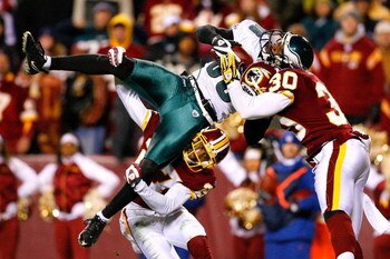 LANDOVER, MD - DECEMBER 21:  Receiver Reggie Brown #86 of the Philadelphia Eagles is stopped just short of the end zone by Fred Smoot #27 and LaRon Landry #30 of the Washington Redskins during the game on December 21, 2008 at FedEx Field in Landover, Mary
