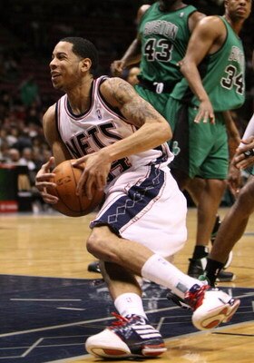 EAST RUTHERFORD, NJ - MARCH 04:  Devin Harris #34 of the New Jersey Nets slips with the ball against the Boston Celtics during their game on March 4, 2009 at The Izod Center in East Rutherford, New Jersey.  NOTE TO USER: User expressly acknowledges and ag