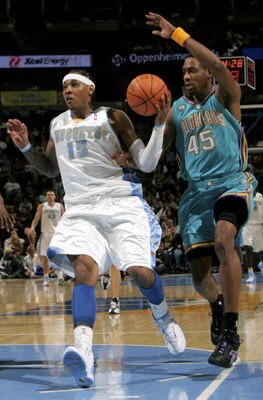 DENVER - FEBRUARY 07:  Carmelo Anthony #15 of the Denver Nuggets trys to control the ball as Rasual Butler #45 of the New Orleans/Oklahoma City Hornets defends during NBA action on February 7, 2007 at the Pepsi Center in Denver, Colorado. The Hornets defe