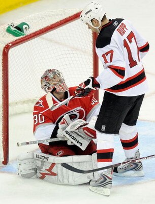 RALEIGH, NC - MARCH 18:  Goalkeeper Cam Ward #30 of the Carolina Hurricanes stops a shot by Mike Rupp #17 of the New Jersey Devils during the second period at the RBC Center on March 18, 2009 in Raleigh, North Carolina.  (Photo by Grant Halverson/Getty Im