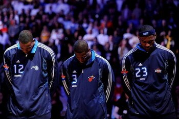 PHOENIX - FEBRUARY 15:  Dwight Howard #12, Dwyane Wade #3 and LeBron James #23 of the Eastern Conference stand during the National Anthem before the 58th NBA All-Star Game, part of 2009 NBA All-Star Weekend at US Airways Center on February 15, 2009 in Pho