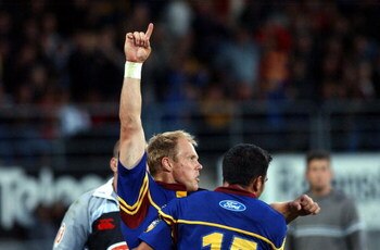 DUNEDIN, NEW ZEALAND - FEBRUARY 04:  Highlanders player Jeff Wilson puts his arms in the air after scoring a try during the Super 12 Rugby game, Sharks vs Highlanders played at Carisbrook, Saturday. The Highlanders won 455.  (Photo by Dean Purcell/Getty I