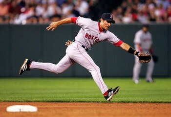 BALTIMORE - JULY 26:   Nomar Garciaparra #5 of the Boston Red Sox lunges for a ball during the 3rd inning against the Baltimore Orioles July 26, 2004 at Camden Yards in Baltimore, Maryland.  (Photo by Jamie Squire/Getty Images)