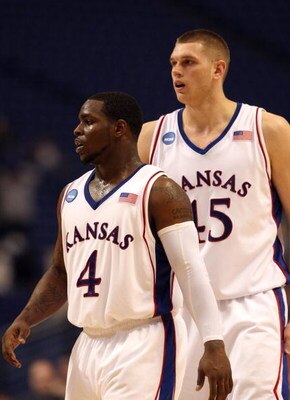 MINNEAPOLIS - MARCH 20:  (L-R) Sherron Collins #4 and Cole Aldrich #45 of the Kansas Jayhawks look on against the North Dakota State Bison during the first round of the NCAA Division I Men's Basketball Tournament at the Hubert H. Humphrey Metrodome on Mar