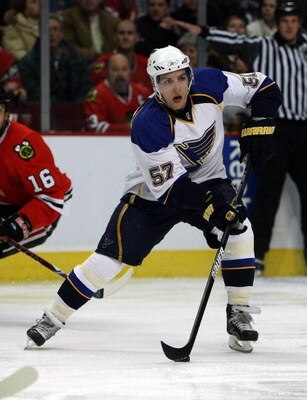 CHICAGO - JANUARY 21: David Perron #57 of the St. Louis Blues looks to pass against the Chicago Blackhawks on January 21, 2009 at the United Center in Chicago, Illinois. The Blues defeated the Blackhawks 2-0. (Photo byJonathan Daniel/Getty Images)