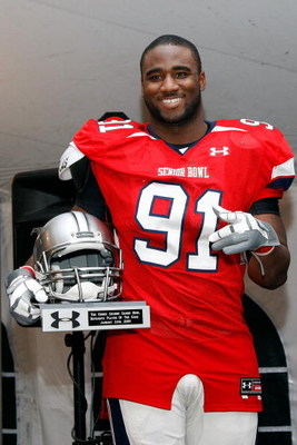 MOBILE, AL - JANUARY 24: Robert Ayers #91 of the South Team accepts the Defensive Player of the game Trophy after defeating the North Team during the Under Armour Senior Bowl on January 24, 2009 at Ladd-Peebles Stadium in Mobile, Alabama. (Photo by Chris