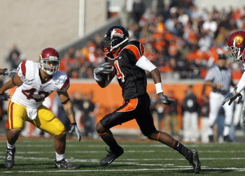 CORVALLIS, OR - OCTOBER 28: Coye Francies #4 of the Oregon State Beavers carries the ball against Kaluka Maiava#43 of the Southern California Trojans at Reser Stadium on October 28, 2006 in Corvallis, Oregon. The Beavers defeated the Trojans 33-31. (Photo