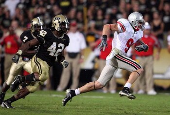 WEST LAFAYETTE, IN - OCTOBER 06:  Brian Hartline #9 of the Ohio State Buckeyes runs away from Anthony Heygood #42 of the Purdue Boilermakers during the game on October 6, 2007 at Ross-Ade Stadium in West Lafayette, Indiana.  (Photo by Andy Lyons/Getty Ima