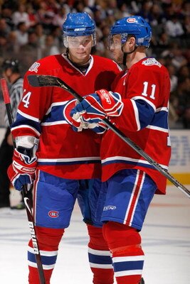 TORONTO - OCTOBER 11:  Sergei Kostitsyn #74 and Saku Koivu #11 of the Montreal Canadiens talk during the game against the Toronto Maple Leafs at the Air Canada Centre October 11, 2008 in Toronto, Ontario. (Photo By Dave Sandford/Getty Images)