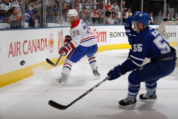 TORONTO - MARCH 29:  Andrei Markov #79 of the Montreal Canadiens moves the puck against Jason Blake #55 of the Toronto Maple Leafs during the game at Air Canada Centre on March 29, 2008 in Toronto, Ontario. (Photo by Dave Sandford/Getty Images)