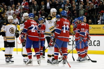 MONTREAL- APRIL 22:  Alexei Kovalev #27 and Georges Laraque #17 of the Montreal Canadiens shake hands with Stephane Yelle #18 and Zdeno Chara #33 of the Boston Bruins after Game Four of the Eastern Conference Quarterfinals of the 2009 Stanley Cup Playoffs