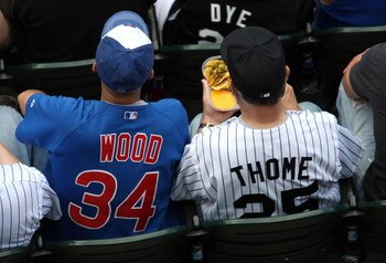 CHICAGO - JUNE 28:  A fan of the Chicago Cubs wearing a Kerry Wood #34 jersey sits next to a fan of the Chicago White Sox wearing a Jim Thome #25 jersey at U.S. Cellular Field on June 28, 2008 in Chicago, Illinois.  (Photo by Jonathan Daniel/Getty Images)