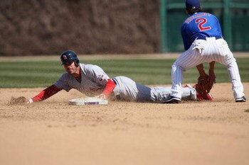 CHICAGO - APRIL 17:  Brian Barden #23 of the St. Louis Cardinals dives into second against Ryan Theriot #2 of the Chicago Cubs on April 17, 2009 at Wrigley Field in Chicago, Illinois. (Photo by Jonathan Daniel/Getty Images) 