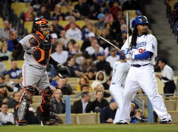 LOS ANGELES, CA - APRIL 16: Manny Ramirez #99 of the Los Angeles Dodgers takes an intentional walk from Bengie Molina #1 of the San Francisco Giants during the second inning at Dodger Stadium on April 16, 2009 in Los Angeles, California. (Photo by Harry H