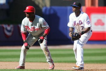 NEW YORK - APRIL 08:  Jimmy Rollins #11 of the Philadelphia Phillies looks to run against Jose Reyes #7 of the New York Mets during the last home opener at Shea Stadium on April 8, 2008 in the Flushing neighborhood of the Queens borough of New York City. 