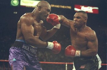 9 Nov 1996:  Mike Tyson (right) throws a right hook at Evander Holyfield during their bout at the MGM Grand Garden in Las Vegas, Nevada.  Holyfield won the bout by way of TKO in the 11th round.  Mandatory Credit: Al Bello  /Allsport