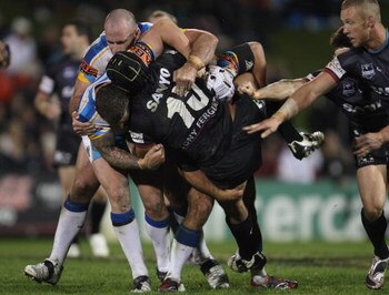 SYDNEY, AUSTRALIA - APRIL 27:  Frank Puletua of the Panthers is hit by strong Titans defence during the round seven NRL match between the Penrith Panthers and the Gold Coast Titans at CUA Stadium on April 27, 2009 in Sydney, Australia.  (Photo by Mark Kol