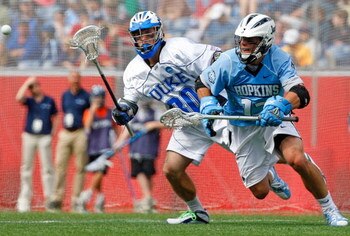 FOXBORO, MA - MAY 24:  Stephen Peyser #12 of the Johns Hopkins Blue Jays races Terrence Molinari #30 of the Duke Blue Devils during NCAA Lacrosse Semifinals at Gillette Stadium on May 24, 2008 in Foxboro, Massachusetts.  (Photo by Jim Rogash/Getty Images)