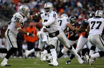 DENVER - NOVEMBER 23:  Quarterback JaMarcus Russell #2 of the Oakland Raiders hands the ball off to Justin Fargas #25 against the Denver Broncos during week 12 NFL action at Invesco Field at Mile High on November 23, 2008 in Denver, Colorado. The Raiders 
