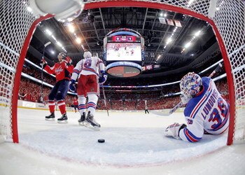 WASHINGTON - APRIL 28:  Henrik Lundquvist #40 of the New York Rangers appears dejected as Alex Ovechkin #8 of the Washington Capitals celebrates the tying goal in the first period during Game Seven of the Eastern Conference Quarterfinal Round of the 2009 