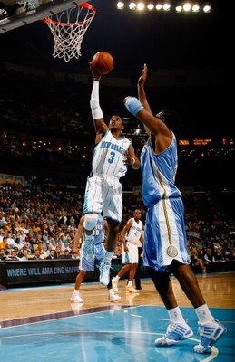 NEW ORLEANS - APRIL 27:  Chris Paul #3 of the New Orleans Hornets makes a shot over #31 Nene of the Denver Nuggets in Game Four of the Western Conference Quarterfinals during the 2009 NBA Playoffs at New Orleans Arena on April 27, 2009 in New Orleans, Lou