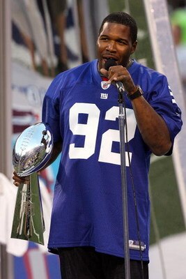 EAST RUTHERFORD, NJ - SEPTEMBER 04:  Former New York Giant Michael Strahan holds the Vince Lombardi Trophy during a pre-game ceremony honoring the Super Bowl Champions prior to a game against the Washington Redskins at Giants Stadium on September 4, 2008 