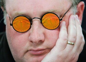 LAS VEGAS - JULY 30:  Poker player Greg 'Fossilman' Raymer, the 2004 World Series of Poker champion, wears his holographic glasses as he competes on the third day of the first round of the WSOP no-limit Texas Hold 'em main event at the Rio Hotel & Casino 
