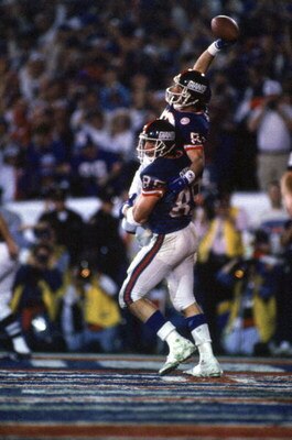 PASADENA, CA - JANUARY 25:  Tight end Mark Bavaro #89 lifts up wide receiver Phil McConkey #80 of the New York Giants after McConkey scored a touchdown against the Denver Broncos during Super Bowl XXI at the Rose Bowl on January 25, 1987 in Pasadena, Cali