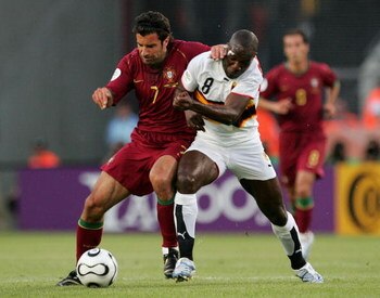 KOLN, GERMANY - JUNE 11:  Luis Figo of Portugal battles with Andre Macanga of Angola during the FIFA World Cup Germany 2006 Group D match between Angola and Portugal at the Stadium Koln on June 11, 2006 in Koln, Germany.  (Photo by Laurence Griffiths/Gett