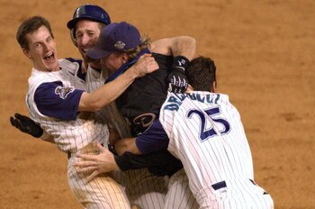 4 Nov 2001: Craig Counsell #4, Luis Gonzalez #20, Curt Schilling #38 and David Dellucci #36 of the Arizona Diamondbacks celebrate defeating the New York Yankees to win game seven of the Major League Baseball World Series at Bank One Ballpark in Phoenix, A