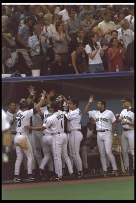 6 Oct 1995: Tino Martinez of the Seattle Mariners is congratulated by his team in the dug out after hitting a home run against the New York Yankees in the Divisional Playoffs of the American League at the King Dome in Seattle, Washington. The Mariners d