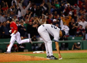 BOSTON - APRIL 24: Jason Bay #44 of the Boston Red Sox hits a two-run home run in the ninth inning to tie the game against Mariano Rivera #42 of the New York Yankees at Fenway Park, April 24, 2009, in Boston, Massachusetts. (Photo by Jim Rogash/Getty Imag