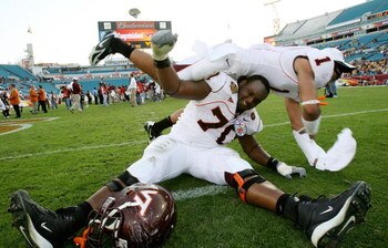 JACKSONVILLE, FL - DECEMBER 1:  Cornerback Victor Harris #1 and offensive lineman Sergio Render #70 of the Virginia Tech Hokies celebrate after defeating the Boston College Eagles in the ACC Championship Game at Jacksonville Municipal Stadium December 1, 