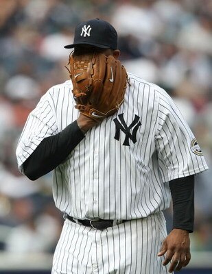 NEW YORK - MAY 02:  CC Sabathia #52 of the New York Yankees screams into his glove in frustration as he is pulled from the game in the seventh inning against the Los Angeles Angels of Anaheim at Yankee Stadium on May 2, 2009 in the Bronx borough of New Yo