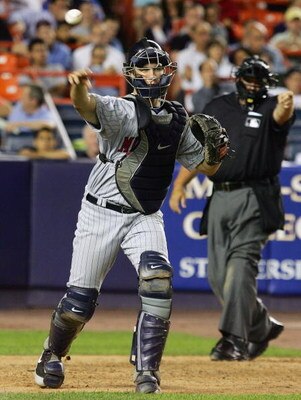 NEW YORK - JUNE 20: Joe Mauer #7 of the Minnesota Twins throws to first against the New York Mets during their inter-league game on June 20, 2007 at Shea Stadium in the Flushing neighborhood of the Queens borough of New York City. (Photo by Jim McIsaac/Ge