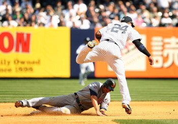 NEW YORK - APRIL 17:  Grady Sizemore #24 of the Cleveland Indians is out at second base as Robinson Cano #24 of the New York Yankees turns a double play on a hit by Mark DeRosa in the seventh inning at Yankee Stadium on April 17, 2009 in the Bronx borough