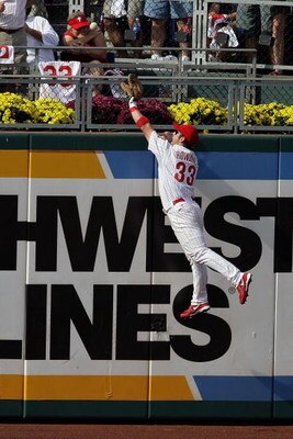 PHILADELPHIA - OCTOBER 04:  Aaron Rowand #33 of the Philadelphia Phillies fails to steal a solo home run hit by Troy Tulowitzki #2 of the Colorado Rockies during Game Two of the National League Divisional Series at Citizens Bank Park on October 4, 2007 in