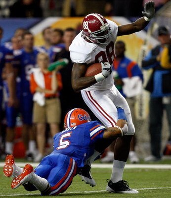 ATLANTA - DECEMBER 06:  Nick Walker #88 of the Alabama Crimson Tide is tackled by Joe Haden #5 of the Florida Gators during the SEC Championship on December 6, 2008 at the Georgia Dome in Atlanta, Georgia.  (Photo by Chris Graythen/Getty Images)