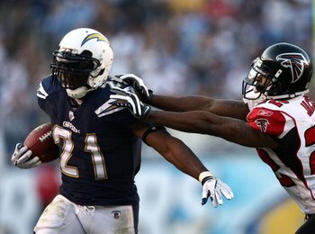 SAN DIEGO, CA - NOVEMBER 30:   Running back LaDainian Tomlinson #21 of the San Diego Chargers runs against the tackle of Chevis Jackson #22 of the Atlanta Falcons during their NFL Game on November 30, 2008 at Qualcomm Stadium in San Diego, California.  (P