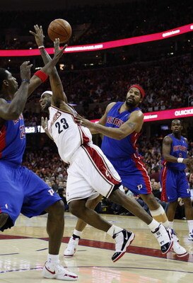 CLEVELAND - APRIL 21:  LeBron James #23 of the Cleveland Cavaliers gets fouled hard by Rasheed Wallace #30 and Antonio McDyess #24 of the Detroit Pistons in Game Two of the Eastern Conference Quarterfinals during the 2009 NBA Playoffs at Quicken Loans Are