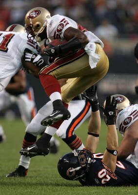 CHICAGO - AUGUST 25:  Moran Norris #44 of the San Francisco 49ers leaps out of the grasp of Adam Archuleta #20 of the Chicago Bears during a preseason game at Soldier Field August 25, 2007 in Chicago, Illinois. (Photo by Jonathan Daniel/Getty Images)
