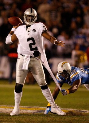 SAN DIEGO - DECEMBER 04:  Quarterback JaMarcus Russell #2 of the Oakland Raiders is grabbed by Linebacker Shaun Philips #95 of the San Diego Chargers during their NFL Game on December 4, 2008 at Qualcomm Stadium in San Diego, California.  (Photo by Harry 