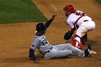 PHILADELPHIA - OCTOBER 27:  B.J. Upton #2 of the Tampa Bay Rays scores on a RBI single by Carlos Pena  in the top of the sixth inning against Carlos Ruiz #51 of the Philadelphia Phillies during game five of the 2008 MLB World Series on October 27, 2008 at