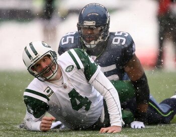 SEATTLE - DECEMBER 21:  Quarterback Brett Favre #4 of the New York Jets looks up after being tackled by Lawrence Jackson #95 of the Seattle Seahawks on December 21, 2008 at Qwest Field in Seattle, Washington. The Seahawks defeated the Jets 13-3. (Photo by