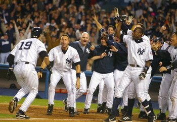 BRONX, NY - OCTOBER 16:  Aaron Boone #19 of the New York Yankees celebrates with his teammates after hitting the game winning home run in the bottom of the eleventh inning against the Boston Red Sox during game 7 of the American League Championship Series